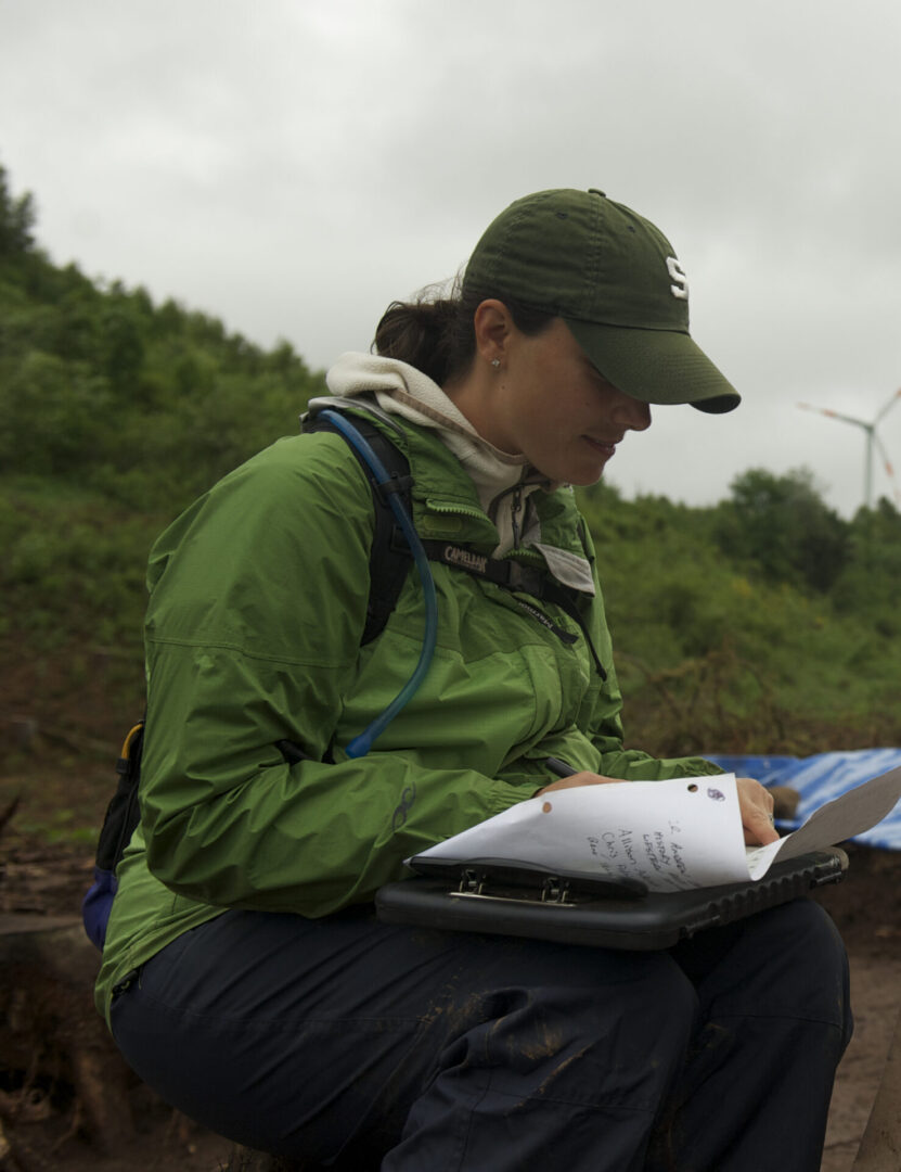 a woman writing on a paper